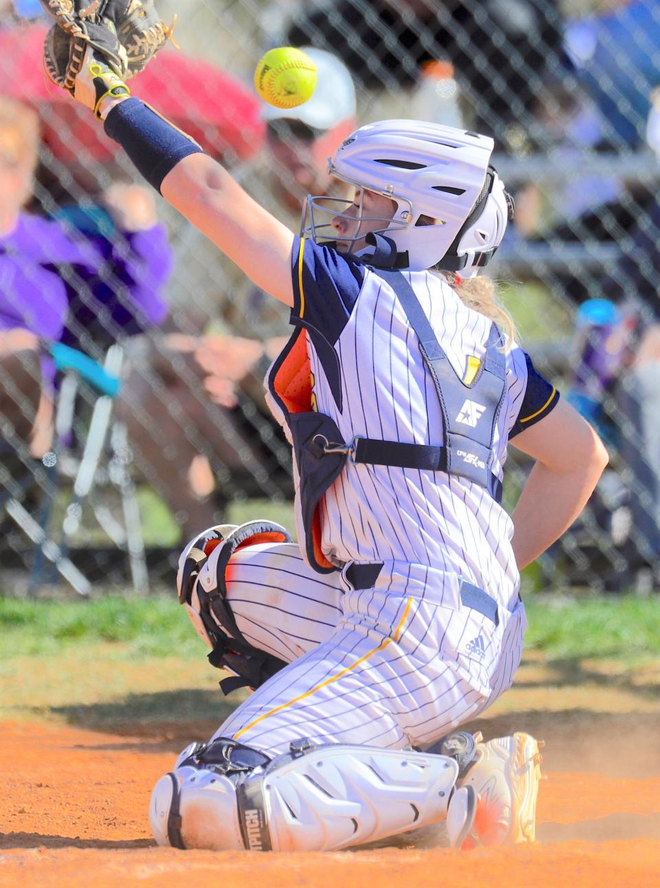 Oklahoma Wesleyan University softball catcher Baylee Knorr watches a foul ball soar backward during 2023 season action.