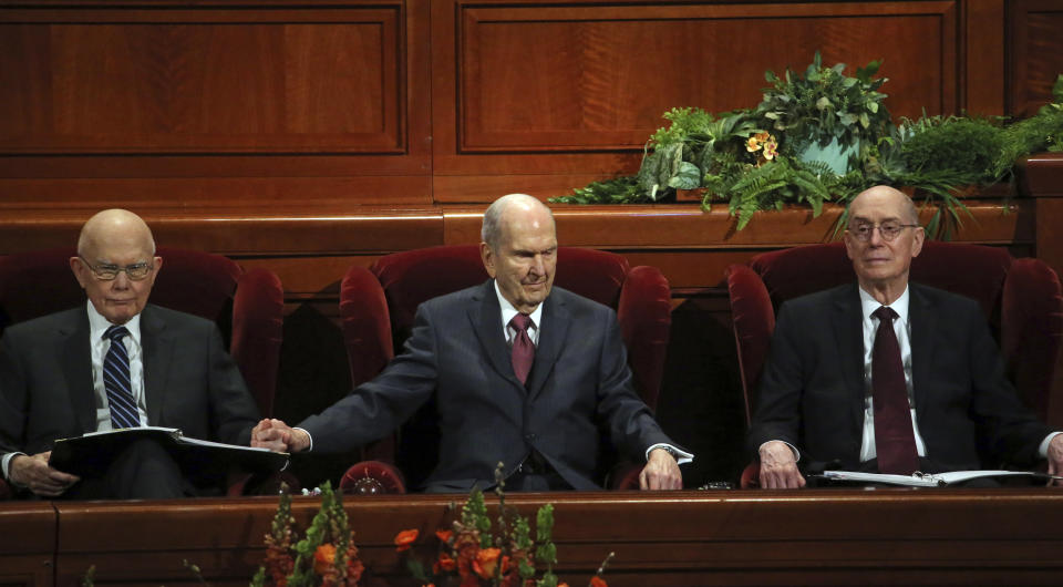 President Russell M. Nelson, center, sits with his counselors, Dallin H. Oaks, left, and Henry B. Eyring, right, during the The Church of Jesus Christ of Latter-day Saints conference Saturday, April 6, 2019, in Salt Lake City. Church members are preparing for more changes as they gather in Utah for a twice-yearly conference to hear from the faith's top leaders. (AP Photo/Rick Bowmer)