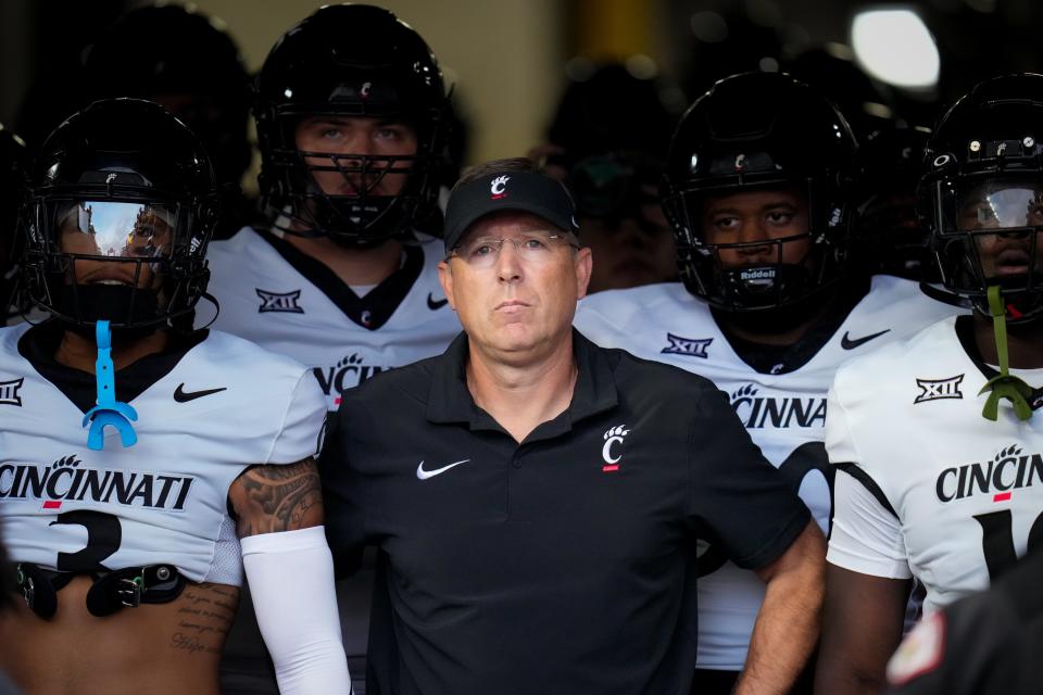 Cincinnati head coach Scott Satterfield leads the Bearcats onto the field for the first quarter at Pittsburgh on Sept. 9.