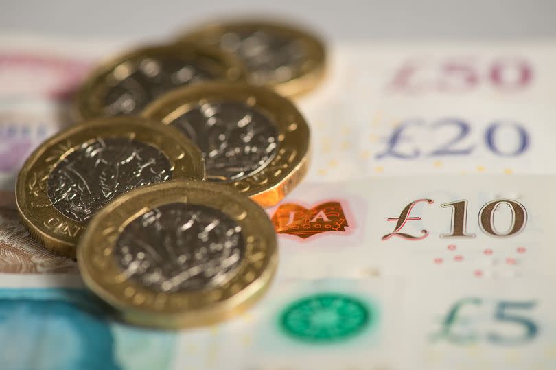 Pile of pound coins and notes