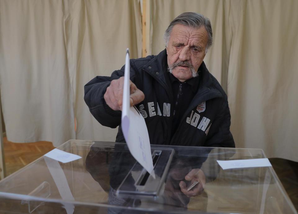 A Bulgarian man casts his vote in Sofia, Bulgaria, Sunday, March 26, 2017. Bulgarians are heading to the polls for the third time in four years in a snap vote that could tilt the European Union's poorest member country closer to Russia as surveys put Bulgarian ex-Premier Boiko Borisov's center-right GERB party neck-and-neck with the Socialist Party. (AP Photo/Vadim Ghirda)