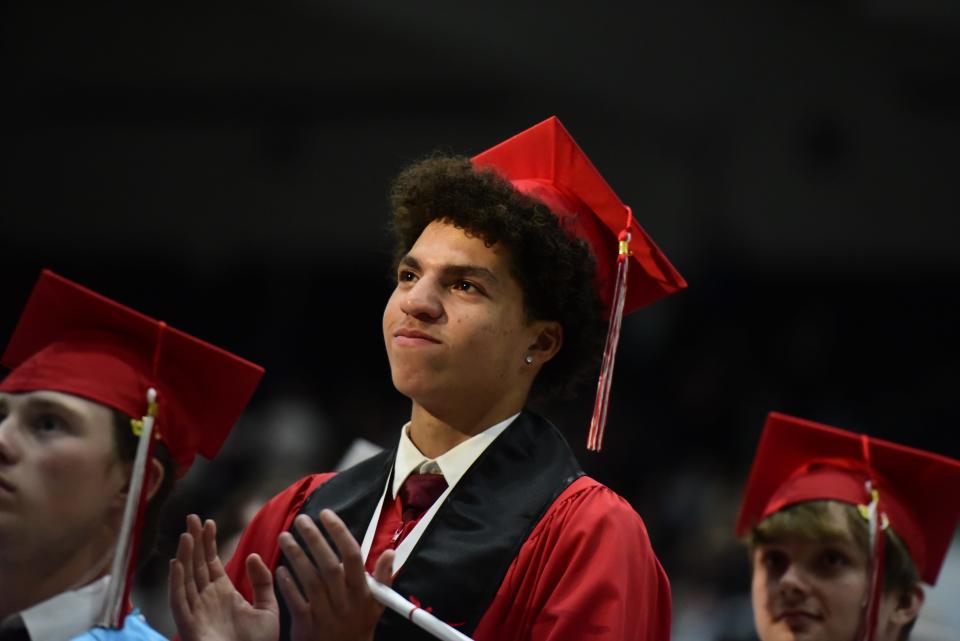 Graduating seniors cheer and smile as the band plays the school's fight song during the Port Huron High School commencement ceremony at McMorran Arena in Port Huron on Wednesday, June 8, 2022.