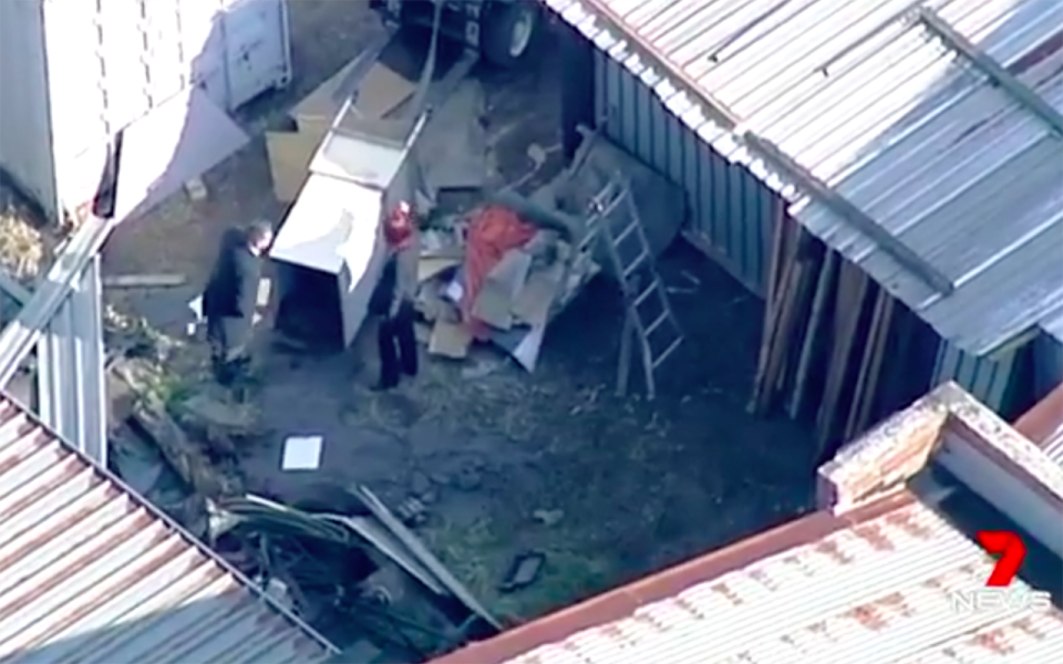 Detectives inspect a crate where human remains were found. Source: 7 News