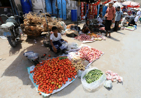 A boy looks on as he sells vegetables at a market in Sadam street in Hodeidah, Yemen March 25, 2019. REUTERS/Abduljabbar Zeyad