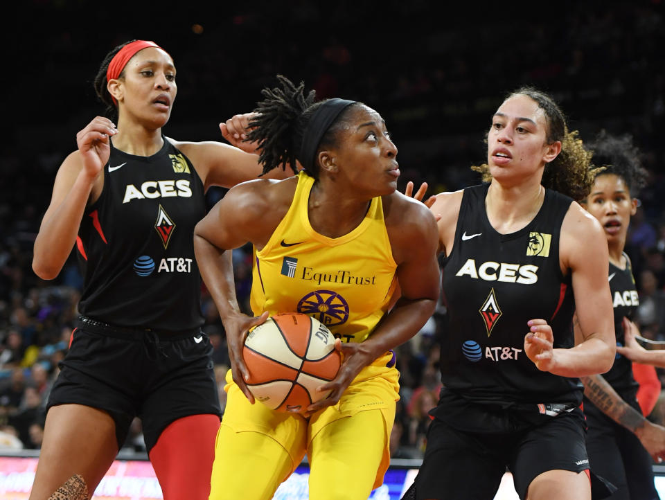 A'ja Wilson on the left and Dearica Hamby on the right guard the Sparks' Nneka Ogwumike. 