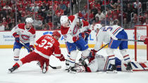 Detroit Red Wings left wing J.T. Compher (37) shoots on Montreal Canadiens goaltender Sam Montembeault (35) in the second period of an NHL hockey game Monday, April 15, 2024, in Detroit. (AP Photo/Paul Sancya)