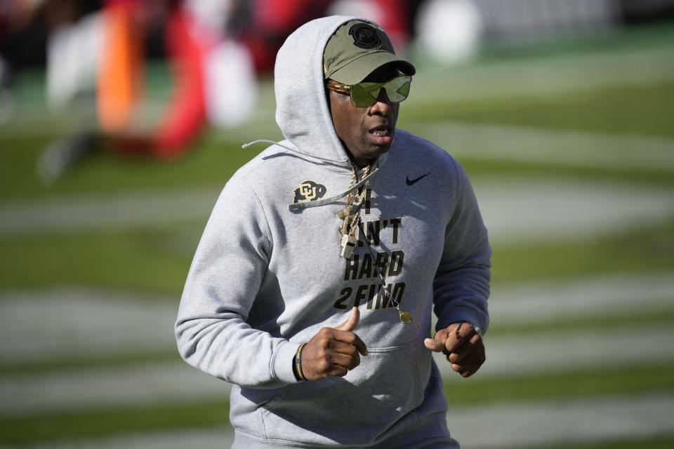 Colorado head coach Deion Sanders runs the perimeter of the field before an NCAA college football game against Arizona, Saturday, Nov. 11, 2023, in Boulder, Colo. (AP Photo/David Zalubowski)