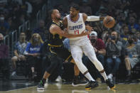 Golden State Warriors guard Stephen Curry (30) defends against Los Angeles Clippers guard Paul George (13) during the first half of an NBA basketball game in Los Angeles, Sunday, Nov. 28, 2021. (AP Photo/Ashley Landis)