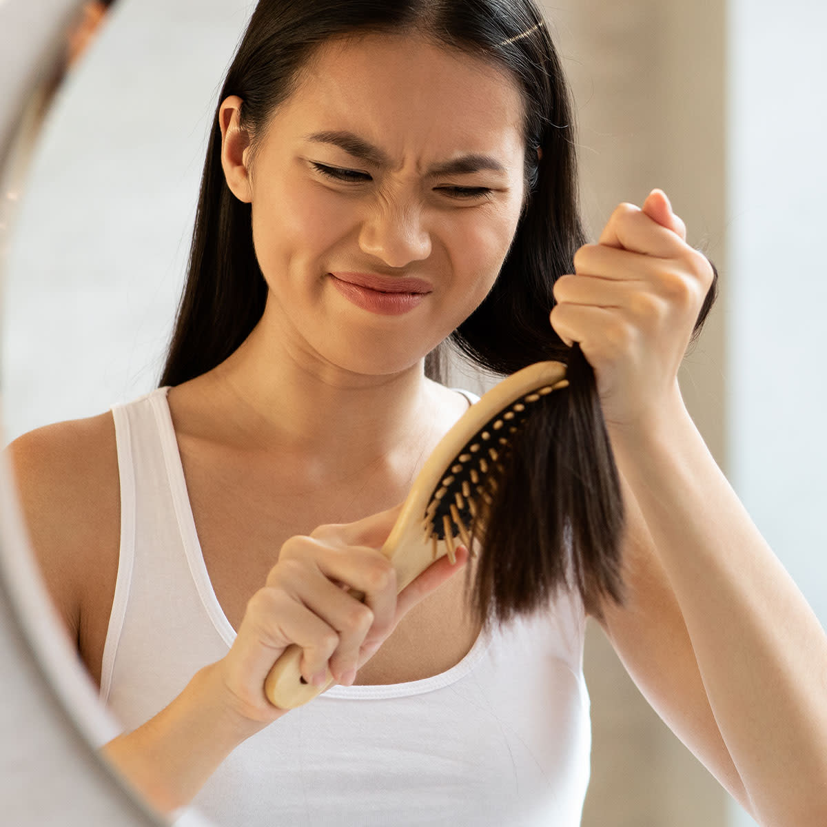 young-woman-brushing-knots-hair