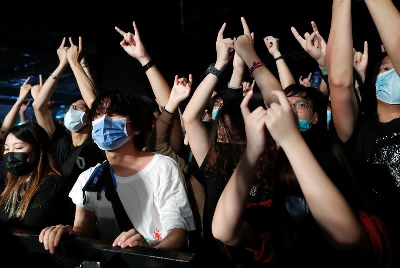 Fans wearing protective masks enjoy a band's performance at Hidden Agenda: This Town Needs (TNN) Live House during the club's last concert as business plummets due to the fear of the coronavirus, in Hong Kong