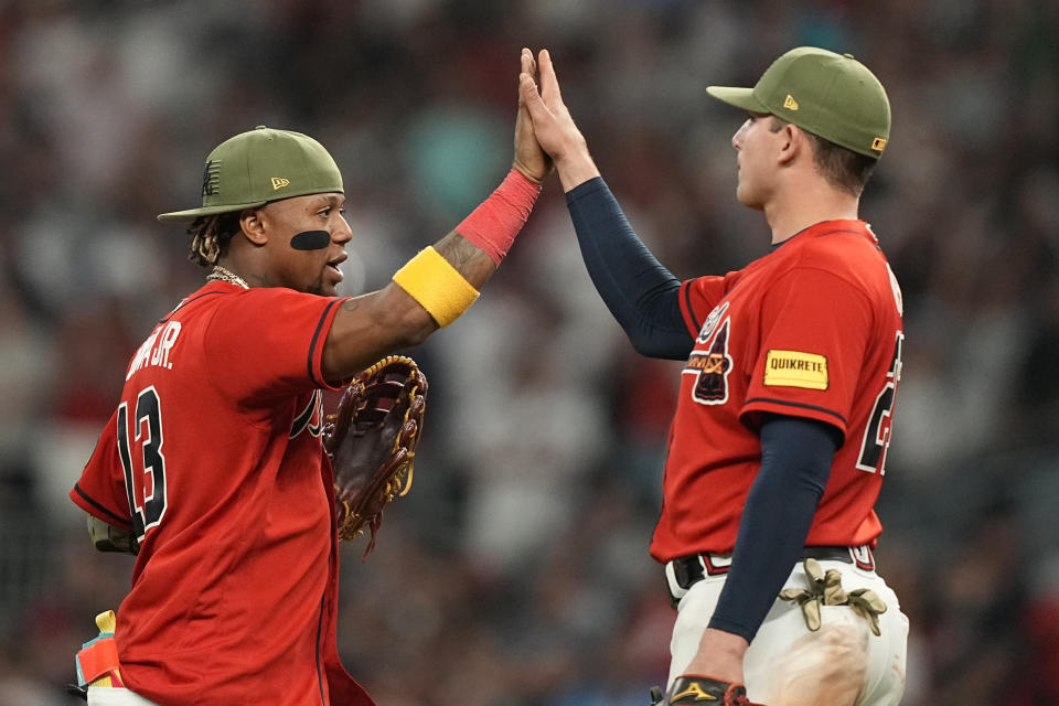 Atlanta Braves' Ronald Acuna Jr., left, celebrates with Austin Riley after the team's win against the Seattle Mariners in a baseball game Friday, May 19, 2023, in Atlanta. (AP Photo/Brynn Anderson)