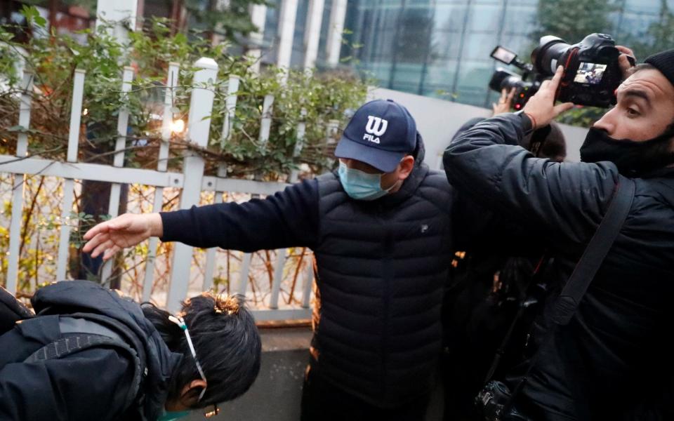 A man attempts to prevent journalists from covering the visit by the WHO team to Hubei Provincial Hospital of Integrated Chinese and Western Medicine, in Wuhan, Hubei province, China - THOMAS PETER/ REUTERS