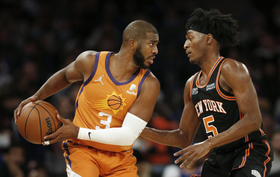 New York Knicks' Immanuel Quickley (5) guards Phoenix Suns' Chris Paul (3) during the first half of an NBA basketball game Friday, Nov. 26, 2021, in New York. AP Photo/John Munson)