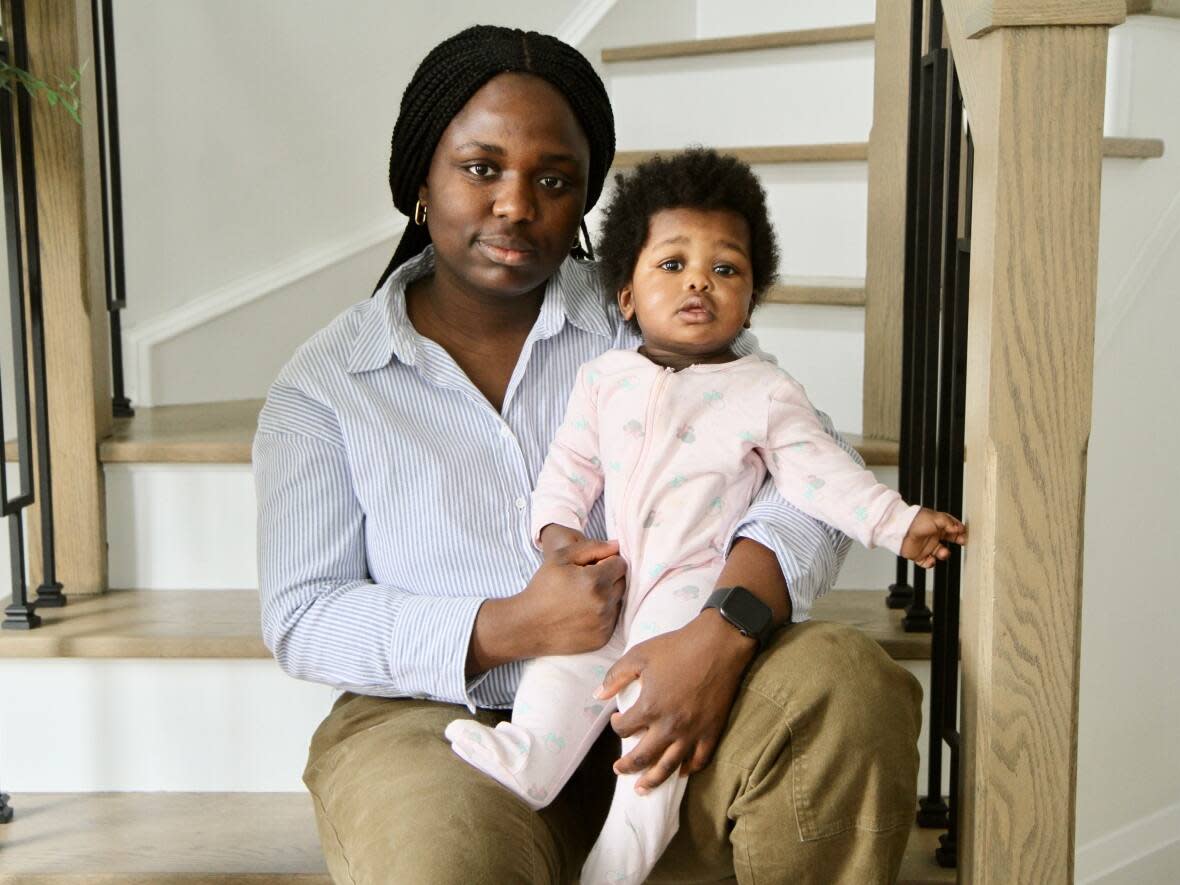 Hamilton resident Eniola Adams, shown with her 10-month-old daughter Azariah Olalekan, says she feels 'stuck' as she looks for child care. The nurse practitioner says she may not even be able to return to work this year. (Samantha Beattie/CBC - image credit)