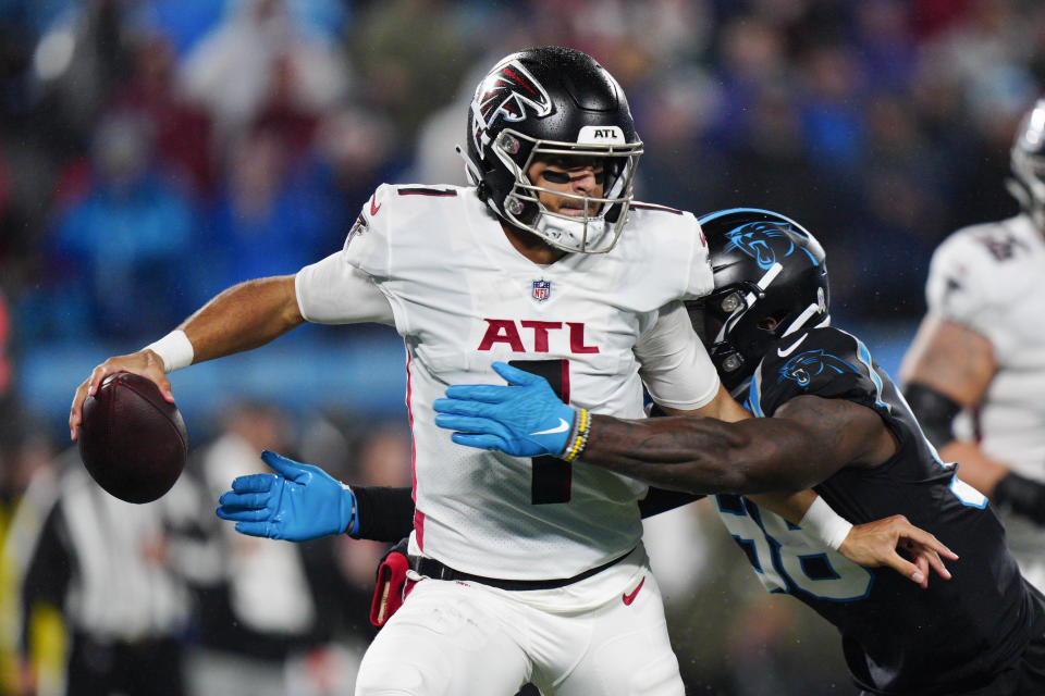 Atlanta Falcons quarterback Marcus Mariota is sacked by Carolina Panthers defensive end Marquis Haynes Sr. during the second half of an NFL football game on Thursday, Nov. 10, 2022, in Charlotte, N.C. (AP Photo/Jacob Kupferman)