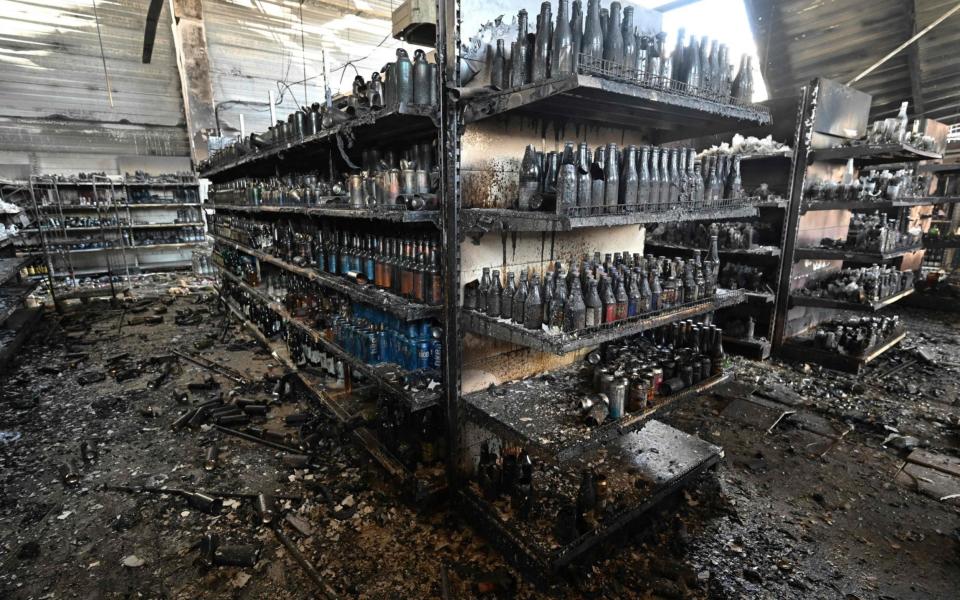 A photograph taken on June 28, 2022 shows charred goods in a grocery store of the destroyed Amstor mall in Kremenchuk, one day after it was hit by a Russian missile strike - GENYA SAVILOV/AFP