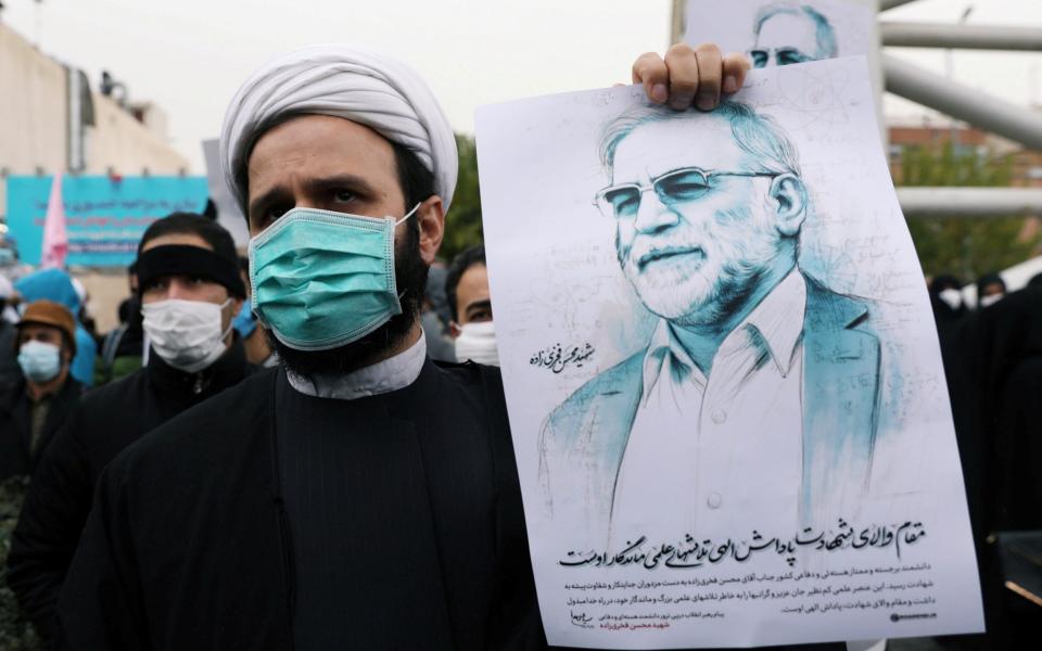 A protester holds a picture of Mohsen Fakhrizadeh, Iran's top nuclear scientist, during a demonstration against his killing in Tehran in November  - WANA/Reuters