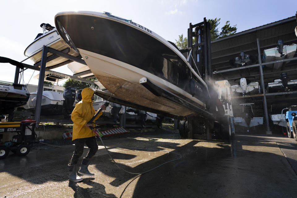 A boat's hull is cleaned after it was pulled out of the water in advance of Hurricane Lee at York Harbor Marine, Thursday, Sept. 14, 2023, in York, Maine. Many boat owners have opted to put their vessels in storage earlier than usual to avoid risking damage from this weekend's storm. (AP Photo/Robert F. Bukaty)