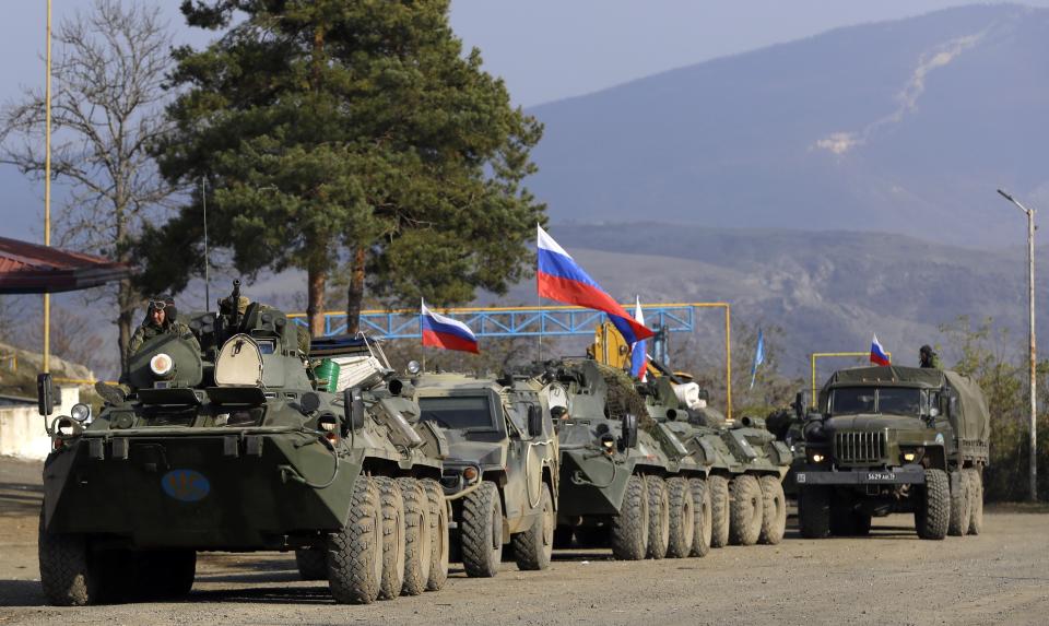 FILE - Russian peacekeepers' vehicles are parked at a checkpoint on the road to Shusha in the separatist region of Nagorno-Karabakh, on Tuesday, Nov. 17, 2020. President Vladimir Putin's spokesman said Wednesday April 17, 2024 that Russian forces are being withdrawn from Azerbaijan's Karabakh region, where they have been stationed as peacekeepers since the end of a war in 2020. (AP Photo/Sergei Grits, File)