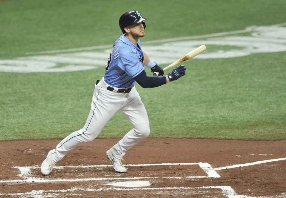 Tampa Bay Rays' Michael Brosseau hits an RBI-double off Boston Red Sox starter Martin Perez during the first inning of a baseball game Sunday, Sept. 13, 2020, in St. Petersburg, Fla. (AP Photo/Steve Nesius)