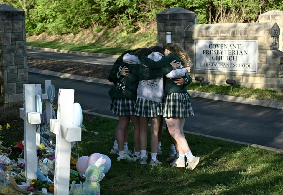 PHOTO: Girls embrace in front of a makeshift memorial for victims by the Covenant School building at the Covenant Presbyterian Church following a shooting, in Nashville, Tenn., on March 29, 2023.  (Brendan Smialowski/AFP via Getty Images)