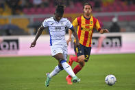 Atalanta's El Bilal Toure', front, plays the ball as Lecce's Antonino Gallo chases during the Serie A soccer match between US Lecce and Atalanta BC at the Via del Mare Stadium, Saturday, May 18, 2024, in Lecce, Italy. (Giovanni Evangelista/LaPresse via AP)
