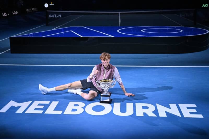 Italian tennis player Jannik Sinner poses with the Norman Brookes Challenge Cup following his victory over Russia's Daniil Medvedev in the Men’s Singles final tennis match of the 2024 Australian Open at Melbourne Park. Joel Carrett/AAP/dpa