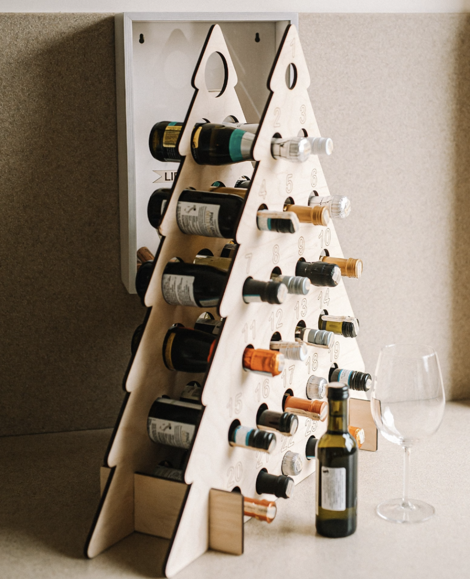 Advent Calendar Wine Bottle Holder in christmas tree shape with wine bottles (Photo via Etsy)