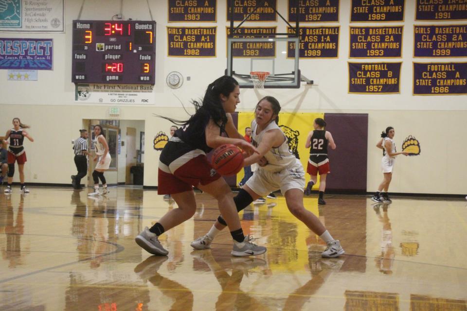 Fowler's Olivia Romero defends against Holly's Noelia Puga in first quarter action Friday night in Fowler. FHS defeated Holly, 61-32.