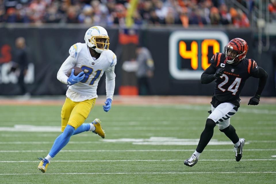 Chargers' Mike Williams (81) breaks free for a long gain while being chased by the Bengals' Vonn Bell in the second half.