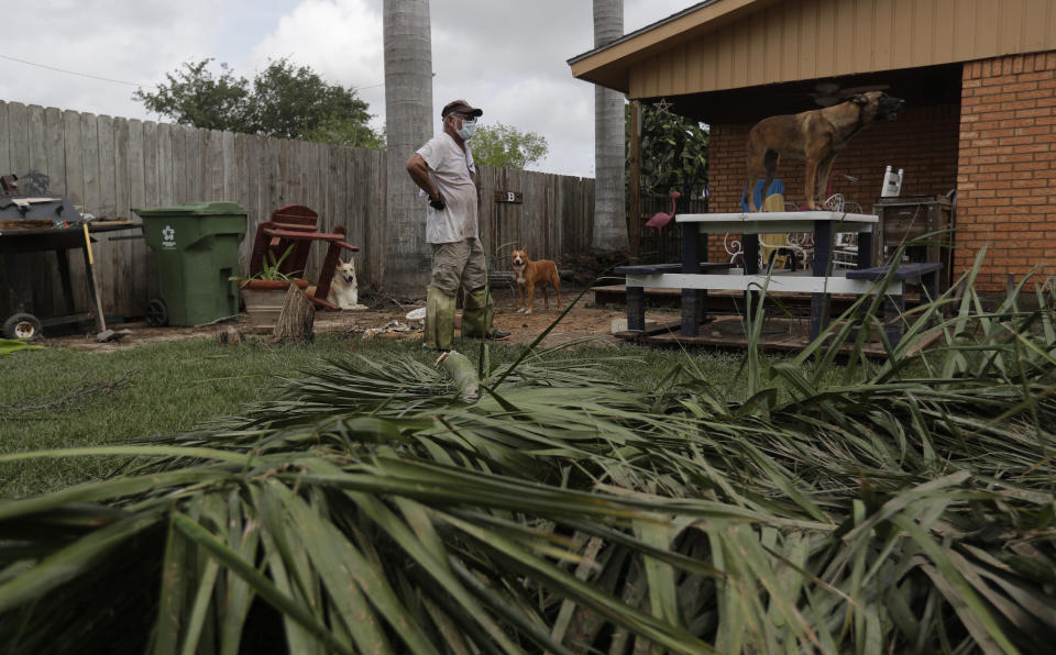 A man assesses damages as he returns to his home, Monday, July 27, 2020, in Weslaco,Texas. Ramos's was flooded by Hurricane Hanna as it passed through the area dropping heavy rains which caused flooding. (AP Photo/Eric Gay)