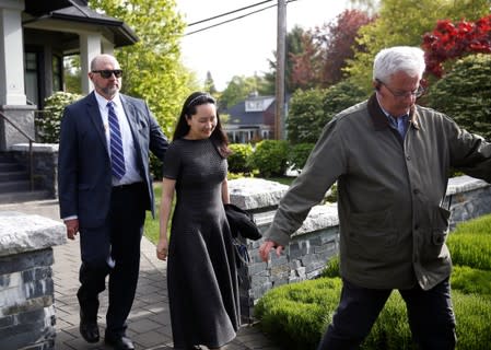 FILE PHOTO: Huawei's Financial Chief Meng Wanzhou leaves her family home flanked by private security in Vancouver, British Columbia