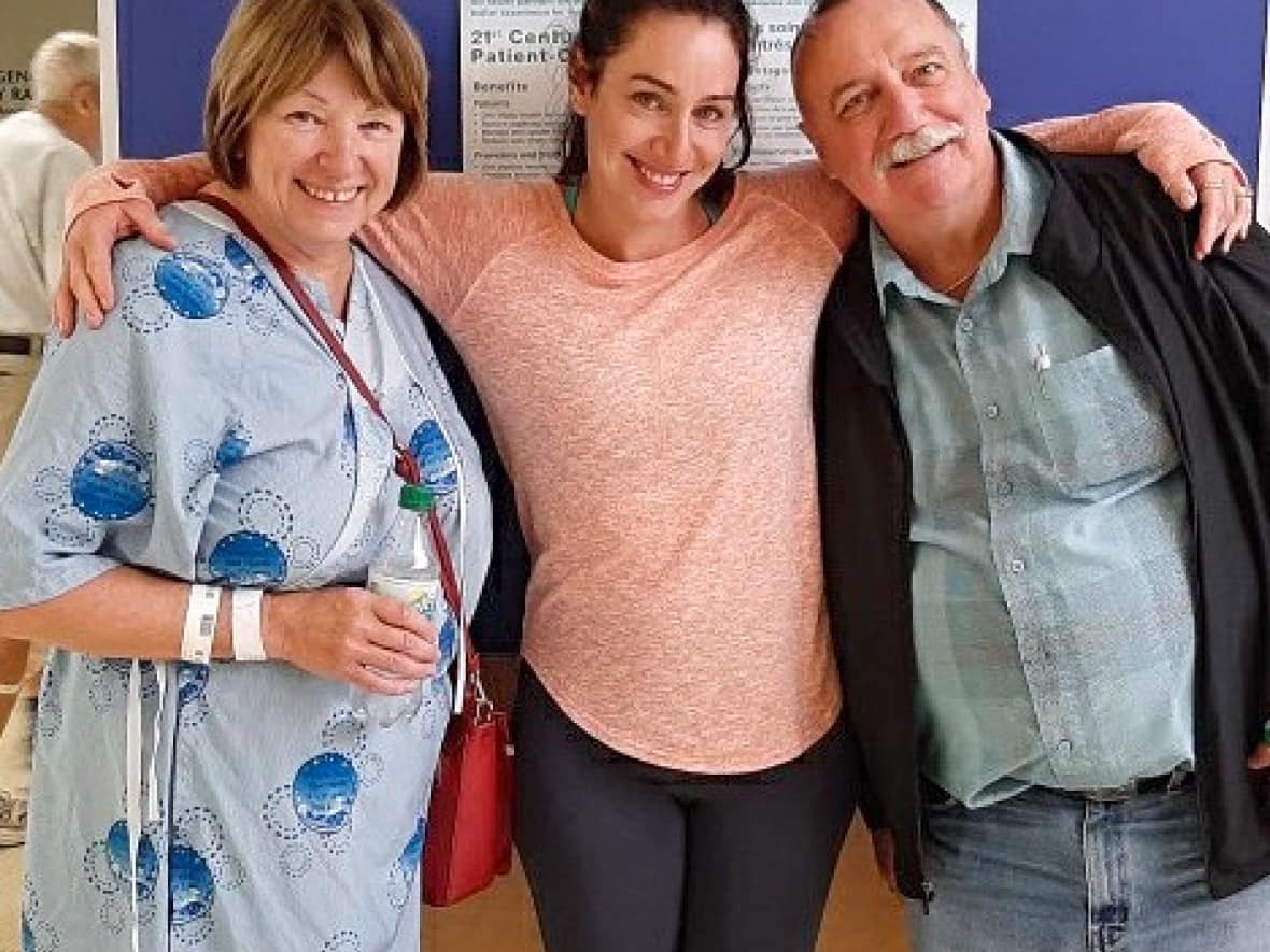 Dill, centre, with her mother Christine Seguin and father Gerry Matthews. Seguin and Matthews were diagnosed with glioblastoma within two weeks of each other in 2019, and both succumbed to the disease the following year. (Submitted by Laura Dill - image credit)