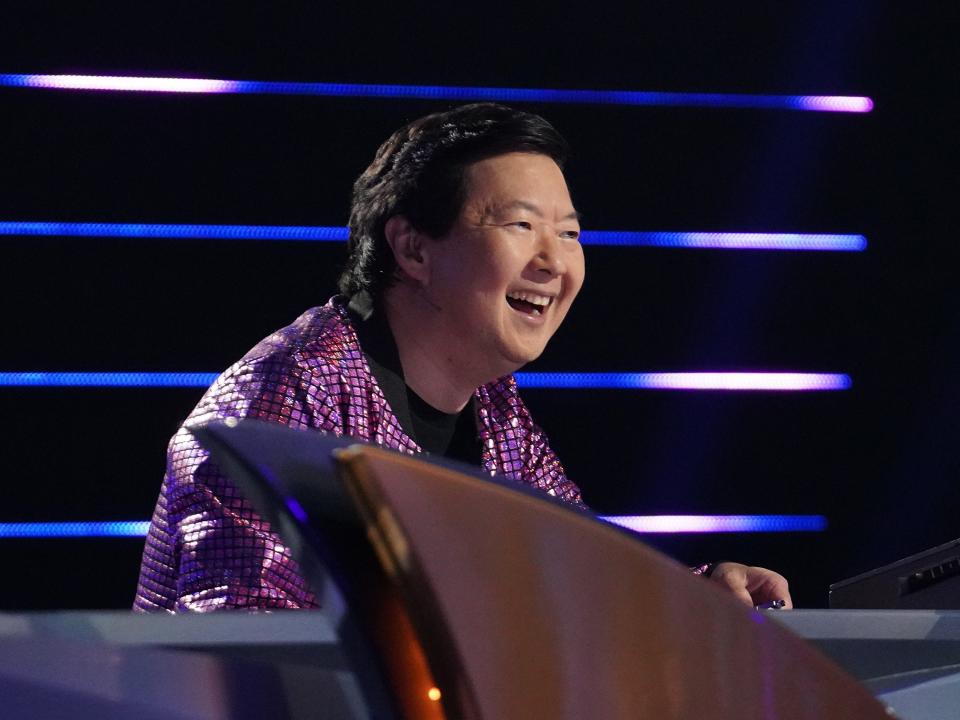 Ken Jeong on "The Masked Singer." He wears a sparkly purple jacket.