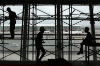 Workers are pictured during renovation and expansion works at Juscelino Kubitschek International Airport in Brasilia March 27, 2014. Brasilia is one of the host cities for the 2014 FIFA World Cup in Brazil. REUTERS/Ueslei Marcelino (BRAZIL - Tags: SPORT SOCCER TRANSPORT TPX IMAGES OF THE DAY)