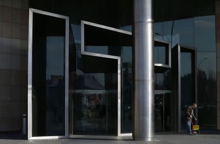 A man cleans the sidewalk in front of the entrance to the ITI headquarters in Warsaw March 16, 2015. U.S. media group Scripps Networks Interactive agreed to buy a majority stake in Polish broadcaster TVN for 584 million euros ($615 million), gaining a foothold in a TV advertising market where revenues beat the global average and grew 6 percent last year. Scripps, which owns the Travel Channel and the Food Network, said it would buy the 52.7 percent stake in Poland's second largest private TV network from local financial holding firm ITI and French media firm Vivendi. REUTERS/Kacper Pempel (POLAND - Tags: MEDIA BUSINESS)