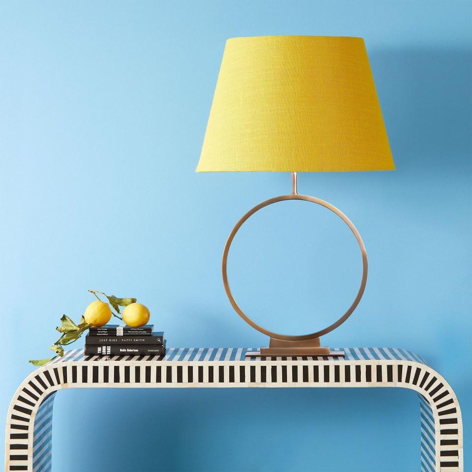 <p>One for the colour lovers, this striking empire lampshade in a bright lemon yellow is a feature in itself. It will match perfectly with blue, as shown here, but yellow is deceptively versatile, making an equally happy match with forest greens, or warm reds. </p><p><strong>Shop now: <a href="https://www.pooky.com/lampshades/50cm-straight-empire-shade-in-acid-yellow-jute-with-pink-lining#selection.config_size=45&selection.shade_fabric_color=JUTYEP" rel="nofollow noopener" target="_blank" data-ylk="slk:Straight Empire Lampshade in Acid Yellow at Pooky;elm:context_link;itc:0;sec:content-canvas" class="link ">Straight Empire Lampshade in Acid Yellow at Pooky</a></strong></p>