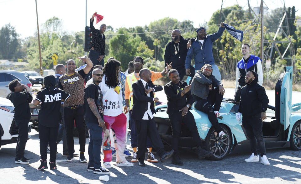 Attendees of a burial service for the late rapper Nipsey Hussle stage a tribute to him as they prepare to leave Forest Lawn Hollywood Hills cemetery, Friday, April 12, 2019 in Los Angeles. (Photo by Chris Pizzello/Invision/AP)