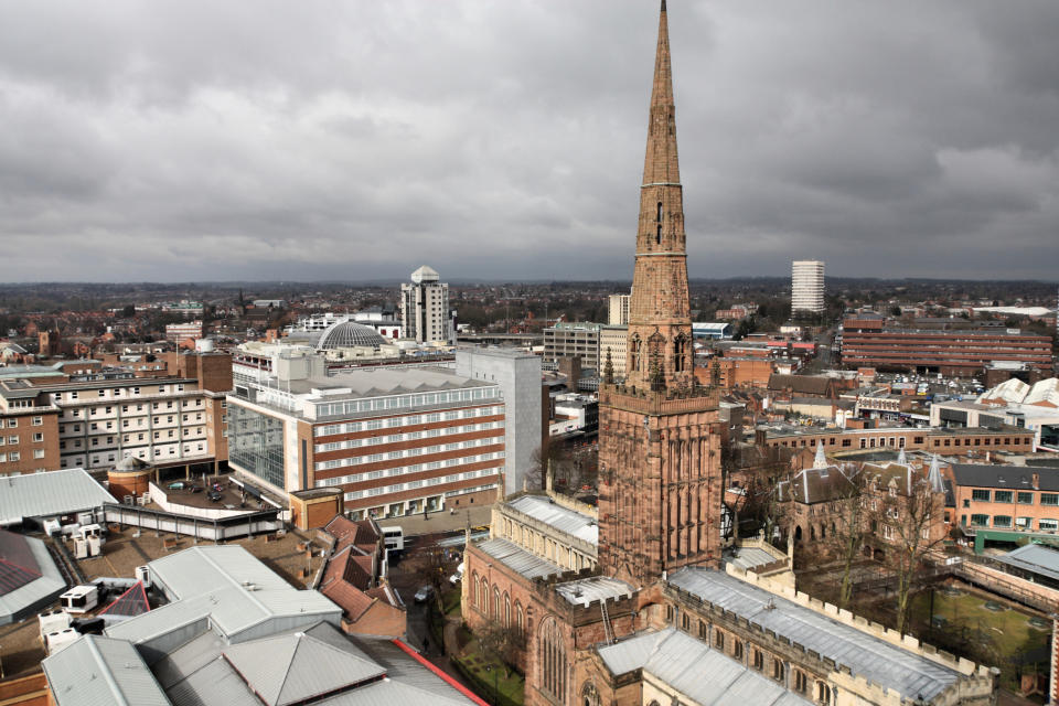 Coventry in West Midlands, England. Old town aerial view from ruined cathedral tower. Prominent Holy Trinity Church.