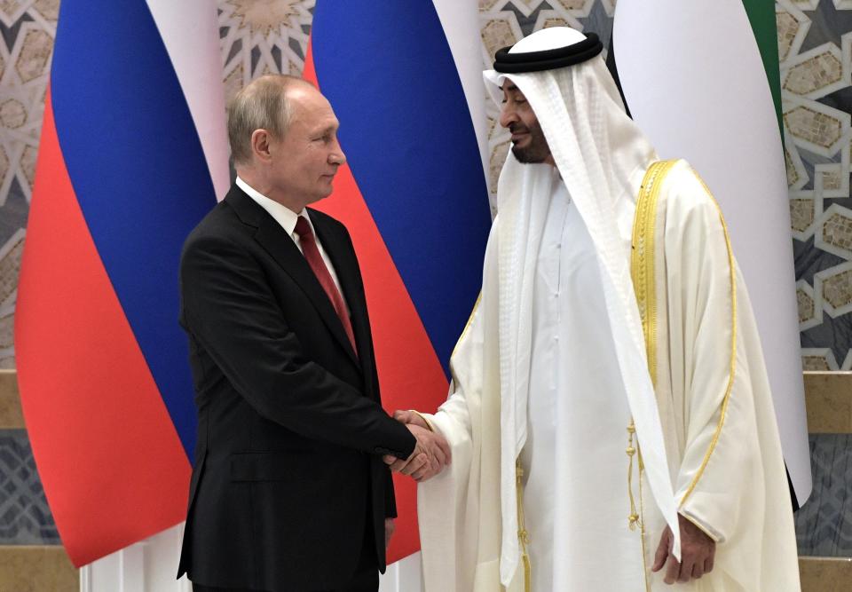 Russian President Vladimir Putin, left, and Abu Dhabi Crown Prince Mohamed bin Zayed al-Nahyan shake hands during the official welcome ceremony in Abu Dhabi, United Arab Emirates, Tuesday, Oct. 15, 2019. (Alexei Nikolsky, Sputnik, Kremlin Pool Photo via AP)