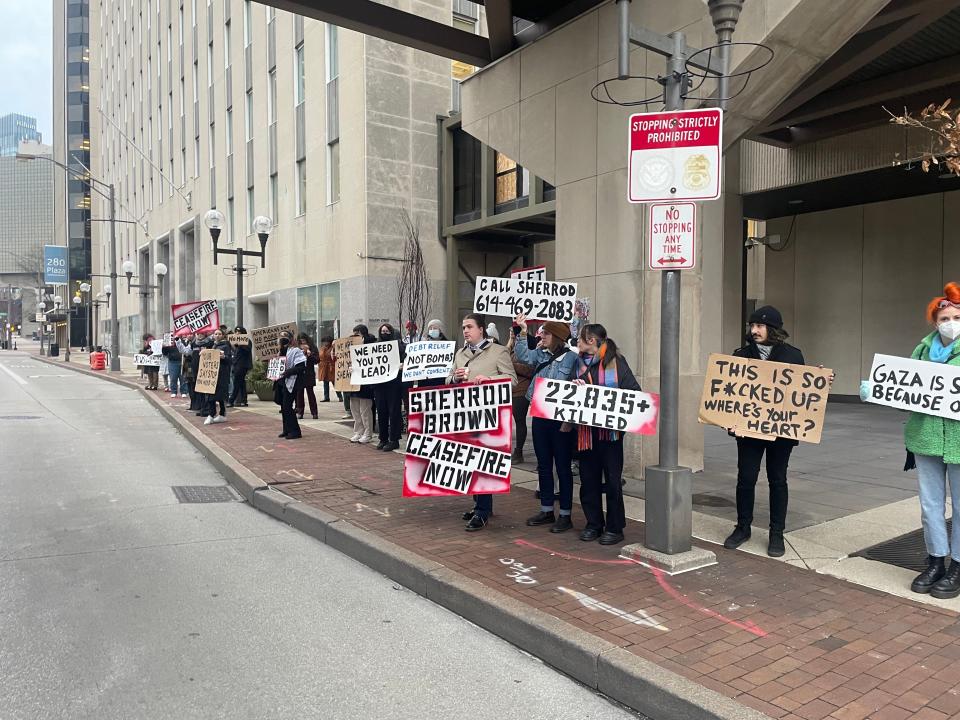 People protested Monday in front of Sen. Sherrod Brown's office in downtown Columbus, demanding he call for a cease-fire in the Israel-Hamas war.