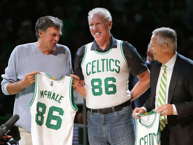 Danny Ainge happily welcomes Kevin McHale and Bill Walton’s belt back to Boston. (Getty Images)