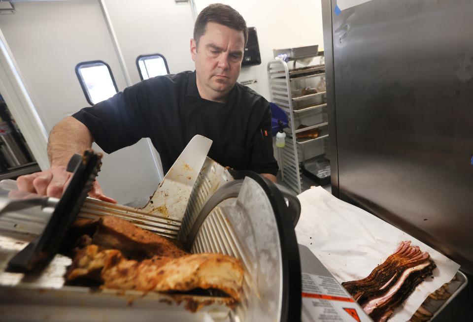 Executive Chef Tom Hughes slices housemade, smoked and cured bacon at his new restaurant Tenero Cafe + Butcher in East Memphis on Friday, April 22, 2022. 