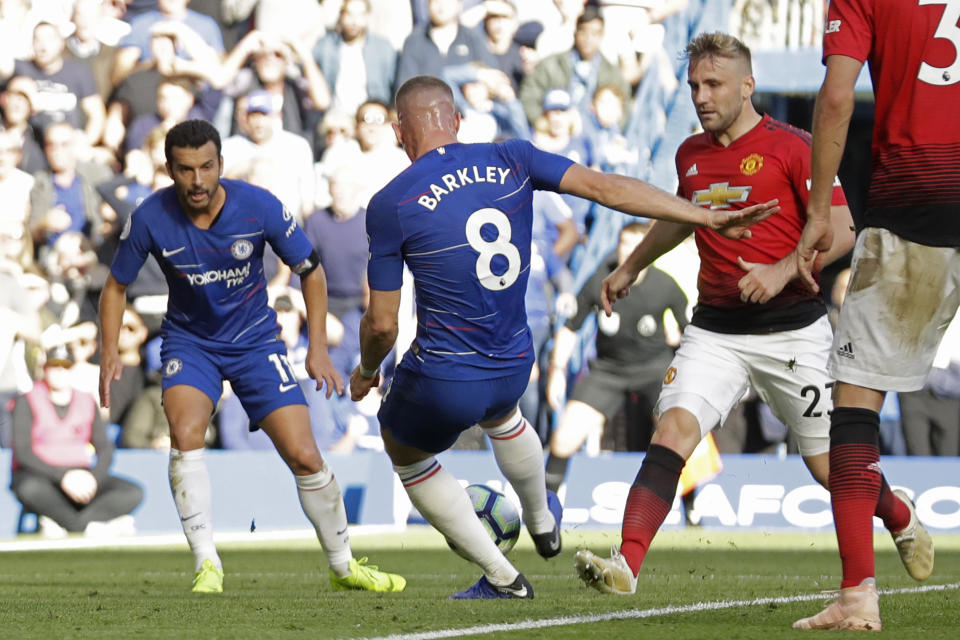 Chelsea's Ross Barkley, center, scores his side's second goal putting the final score at 2-2 during their English Premier League soccer match between Chelsea and Manchester United at Stamford Bridge stadium in London Saturday, Oct. 20, 2018. (AP Photo/Matt Dunham)
