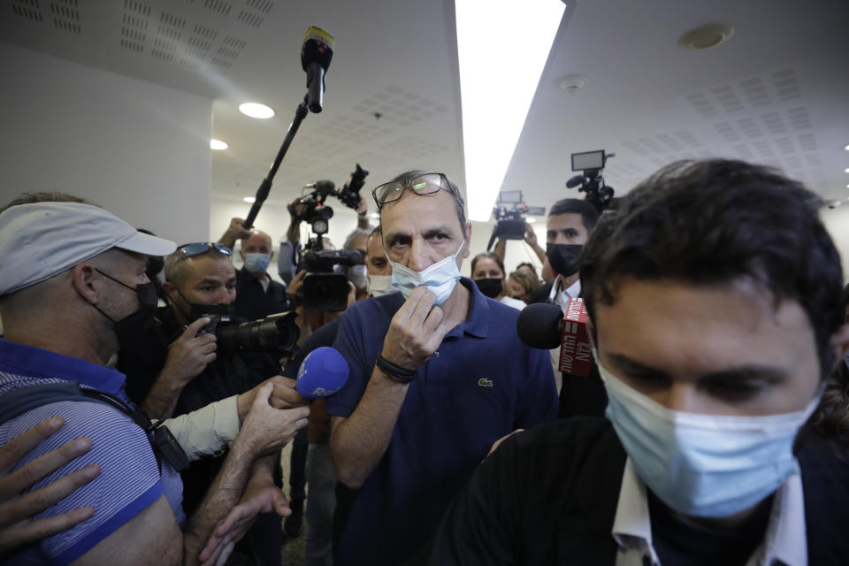 Shmulik Peleg, maternal grandfather of Eitan Biran, who survived a cable car crash in Italy that killed his immediate family, leaves court in Tel Aviv on Thursday, Sept. 23, 2021 for a hearing on charges of kidnapping his grandson. The boy's parents and younger sibling were among 14 killed in May when a cable car slammed into a mountainside in northern Italy. He is now the focus of a custody battle between his maternal grandparents in Israel and his paternal relatives in Italy. (AP Photo/Sebastian Scheiner)