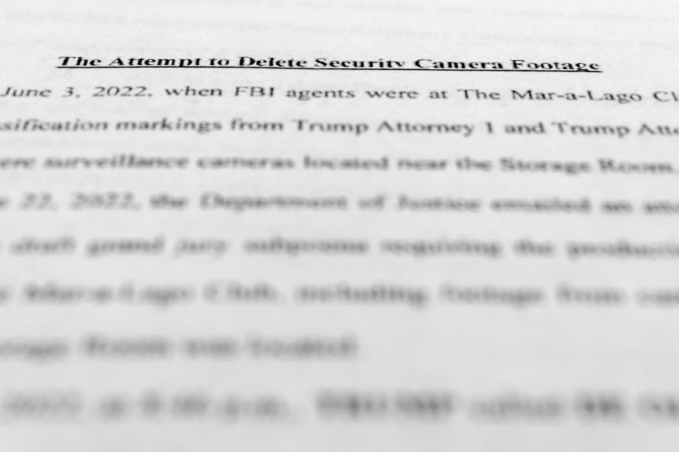 The updated indictment against former President Donald Trump, Walt Nauta and Carlos De Oliveira is photographed Thursday, July 27, 2023. Trump is facing accusations that he and aides asked a staffer to delete camera footage at his Florida estate in an effort to obstruct the classified documents investigations. The allegations were made Thursday in an updated grand jury indictment that adds new charges against Trump and adds another defendant to the case. (AP Photo/Jon Elswick)