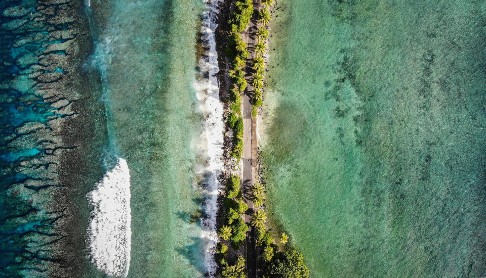 The narrowest point of Fongafale island, in Funafuti, Tuvalu. Scientists predict the low-lying South Pacific island nation could become inundated and uninhabitable in 50 to 100 years or less if sea level rise continues.  (Photo: Mario Tama via Getty Images)