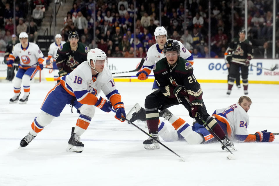 Arizona Coyotes center Barrett Hayton (29) carries the puck on New York Islanders left wing Anthony Beauvillier (18) in the third period during an NHL hockey game, Friday, Dec. 16, 2022, in Tempe, Ariz. Arizona won 5-4. (AP Photo/Rick Scuteri)