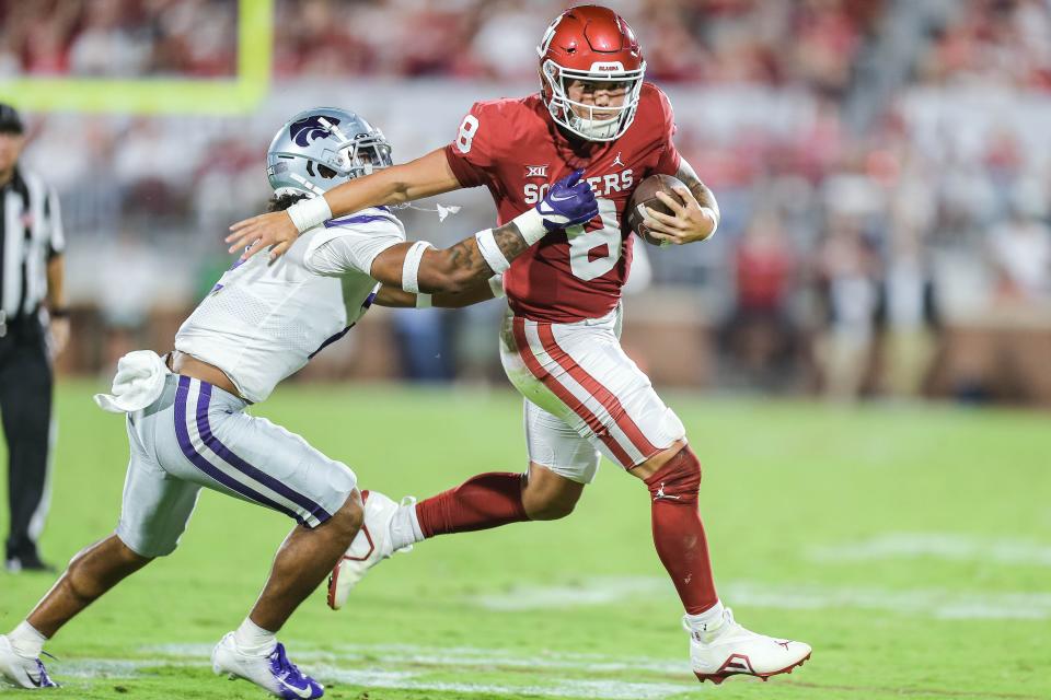 Kansas State safety Kobe Savage grabs Oklahoma QB Dillon Gabriel  duirng K-State's win over the Sooners last weekend