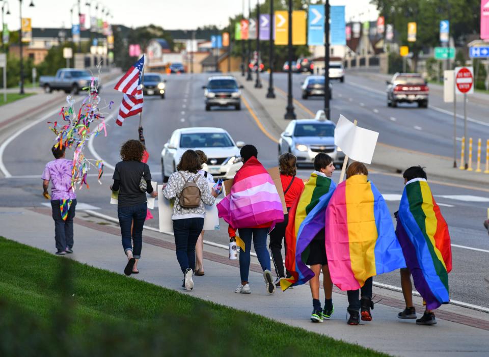 Marchers make their way toward Lake George from the St. Cloud Library during the Community Pride and Peace Walk Tuesday, Sept. 14, 2021, in St. Cloud.